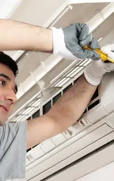 Air conditioner technician servicing indoor