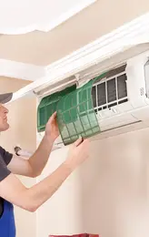 Air conditioner technician servicing indoor