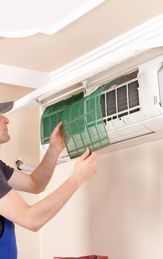 Air conditioner technician servicing indoor