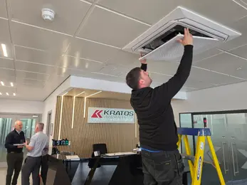 engineers inspecting an air con vent