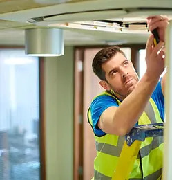air con maintenance engineer in empty office floor