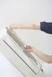 An engineer fixing an Air Conditioner unit