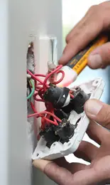 A qualified electrical engineer replacing a plug in Worcestershire