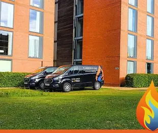 Supporting Cranfield University with Reliable Heating & Plumbing Solutions this image shows two of our vans at Cranfield student accomodation