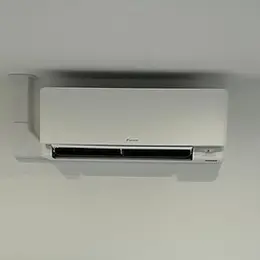 Wall-mounted air conditioner unit in off-white against a light-coloured wall