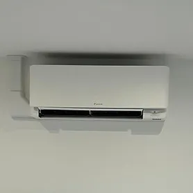 Wall-mounted air conditioner unit in off-white against a light-coloured wall