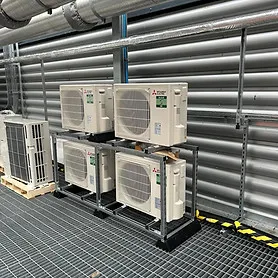 Industrial rooftop with five air conditioning units on metal platforms
