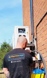 ThermoCool engineer checking operating codes to troubleshoot an air conditioning system.